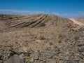 Road trip through rock mountain dried dusty landscape background of Namib desert with splitting shale pieces and other stone