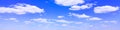 Blue sky background with tiny white clouds, panorama. Royalty Free Stock Photo