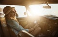 Road-tripping in style. a young woman enjoying a road trip along the coast. Royalty Free Stock Photo