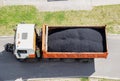 Road truck with a full body of asphalt for laying on the road. Road repair, road equipment.