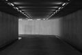 Road tunnel black and white, night illuminated, Urban tunnel without traffic, illuminated city highway tunnel with spotlights Royalty Free Stock Photo