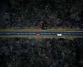 Road with two cars with motion blur from above by drone - night time photo in Lanzarote. Straight road among the lavas on the