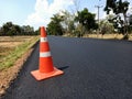 The road is under construction and has a red rubber cone on the road Royalty Free Stock Photo