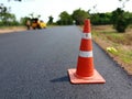 The road is under construction and has a red rubber cone on the road Royalty Free Stock Photo