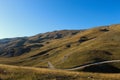 Road through the unevenness of the Bosnian mountain Bjelasnica. It has a golden color before sunset Royalty Free Stock Photo
