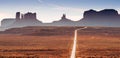 Road in the Utah desert with mountain plateaus, buttes or mesas