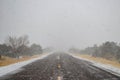 The road vanishing into a snowstorm before my eyes