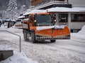 Road Vehicle Snowplow in action on Whitewashed Roads During a Snowy Day Royalty Free Stock Photo