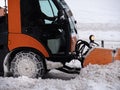 Road Vehicle Snowplow in action on Whitewashed Roads During a Snowy Day Royalty Free Stock Photo