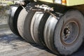 Road vibratory rollers powerfully compact fresh asphalt on a road construction site against the background of a city