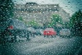 Road view through car window with rain drops. Car window on a rainy day. Highway view, background is out of focus Royalty Free Stock Photo