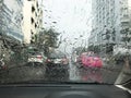 Road view through car window with rain drops, Driving in rain Royalty Free Stock Photo