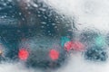 Road view through car window with rain drops and melting snow. Royalty Free Stock Photo