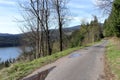 A road with a view of the lake. Sunny spring day in the mountains Royalty Free Stock Photo