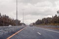 Road view through windshield car window with going rain drops during driving at speed. Unfocused highway. Autumn. Royalty Free Stock Photo