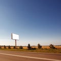 Road in a village with an empty billboard Royalty Free Stock Photo