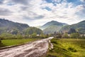 Road and village in green mountain valley Royalty Free Stock Photo