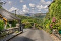 A road through a village leading to mountains. Royalty Free Stock Photo
