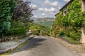 A road through a village leading to mountains. Royalty Free Stock Photo