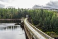 A road and a walkway on top of Laggan Dam construction, Scotland