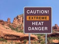 Road warning sign CAUTION! EXTREME HEAT DANGER with mountain
