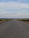 Road between wheat fields before harvest Royalty Free Stock Photo