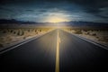 landscape with a road crossing the desert of death valley in California with the mountains in the background Royalty Free Stock Photo