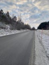 Road, winter and clouds Royalty Free Stock Photo