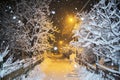 Road in winter night with yellow light. it`s snowing