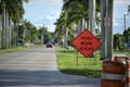 Road work ahead sign and barrier cones on street site as warning to cars about construction and utility works