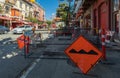 Road work on a street of a city. Street view of road construction site with orange traffic cones and signs of road works Royalty Free Stock Photo