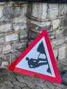Road Work Warning Sign Leaning Against Stone Wall Royalty Free Stock Photo