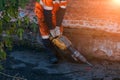 Road worker drilling asphalt on pavement with jackhammer Royalty Free Stock Photo