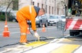 Road worker painting pedestrian crossing line Royalty Free Stock Photo