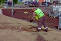 A road worker prepares the foundation for laying paving slabs.leveling the sand cushion Royalty Free Stock Photo