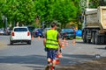 Road worker in protective clothes on the repair of the road