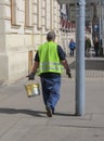 Road worker with yellow paint bucket