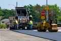 Road workers with asphalt