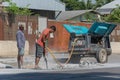 Road workers breaking street