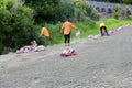 Road workers emptying cement bags on broken road in Northland New Zealand