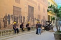 Road workers near the historical painted wall in Havana