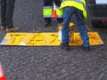 Road workers paint lane markings for taxis with yellow Marcas Viales color in Portugal