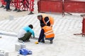Road workers repair the sidewalk in Istanbul near the Galata Bridge