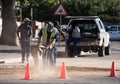 Workmen using an earth compactor in South Africa