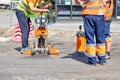 Road workers use a core drilling machine to take cores from an asphalt pavement during road repairs Royalty Free Stock Photo