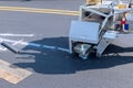 Road workers use hot-melt scribing machines to painting line on asphalt road