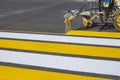 Road workers use hot-melt scribing machines to painting pedestrian crosswalk on asphalt road surface in the city