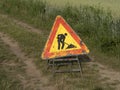 Road working sign on country road Royalty Free Stock Photo
