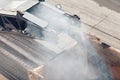 Road works. Asphalt removing machine loading powdered asphalt on the truck Royalty Free Stock Photo