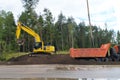 Road works, bulldozer and dump truck widen the road Royalty Free Stock Photo